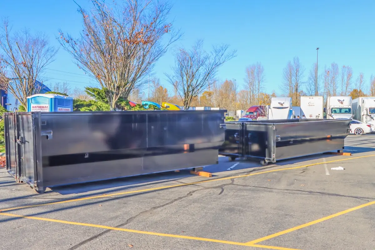 Professional dumpster rental service with roll-off container on residential driveway in Gadsden